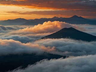 Fototapeta premium Mountains shrouded in clouds with a blue-orange sky.
