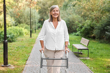 Senior woman with walking frame in park