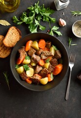 Beef stew with potatoes, carrots and greens