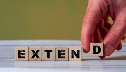 A hand placing the last letter to form the word 