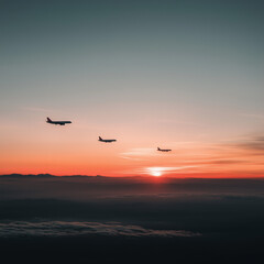 Fototapeta premium Three airplanes flying at sunset with scenic sky