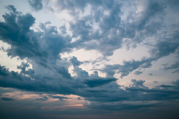 Obraz premium Dense clouds in shades of gray, dramatic storm sky atmosphere