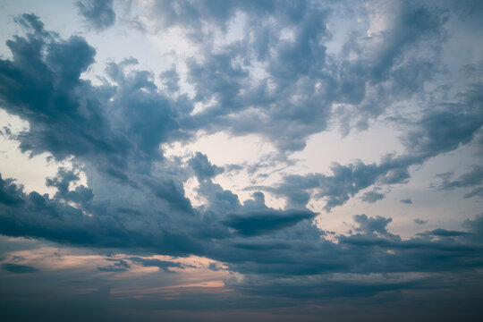Dense clouds in shades of gray, dramatic storm sky atmosphere