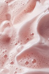 Fototapeta premium Close-up of pink foam texture with bubbles and light reflections