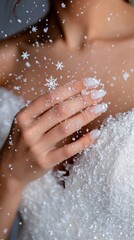 A woman in a bathtub covered in snow with snowflakes falling from her hands