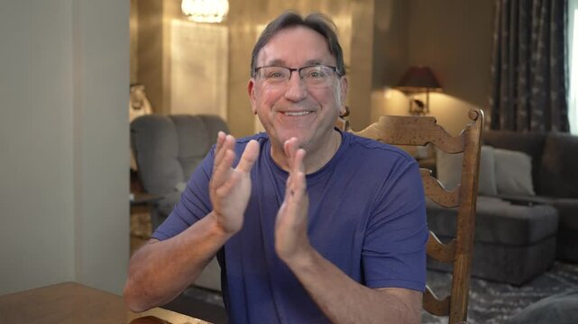 Man gives approval gesture to camera.  	