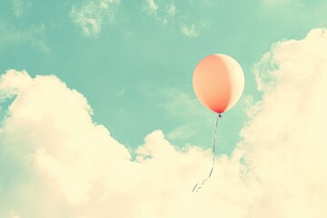 Obraz premium A Single Peach Balloon Ascends In A Cloudy Sky