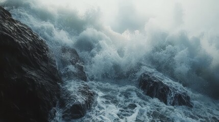 Fototapeta premium Powerful ocean waves crashing against dark rocks.