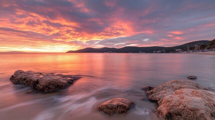 Beautiful colorful sunset sky with bright clouds sun rays over the ocean.