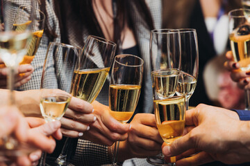 Group of businessmen celebrate, closing successful concluded deal, guests clinking raise glasses with alcohol, sparkling wine, toasting and cheering, colleagues team in office on corporate party event