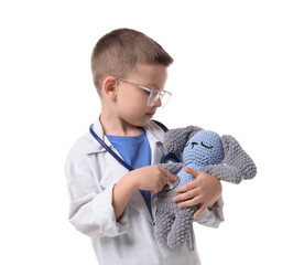 Little boy with stethoscope and toy pretending to be doctor on white background. Dreaming of future...