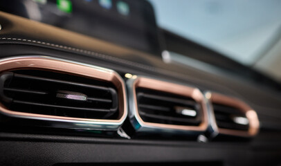 Obraz premium Closeup of car dashboard air vents near gear shift