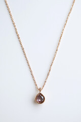 Fototapeta premium A dainty necklace illustration with a gemstone pendant on a plain white backdrop