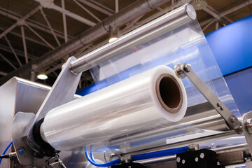 Automatic polyethylene plastic bag production machine with lighting effect. Close-up of the roller...