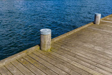 Fototapeta premium Wooden port with mooring places for boats and ships
