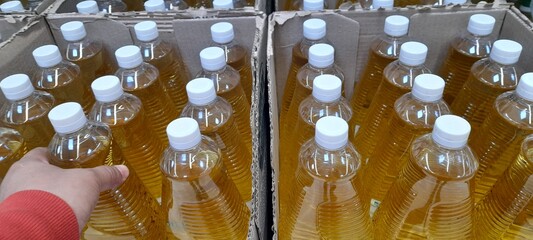 person buying a bottle of oil from a box