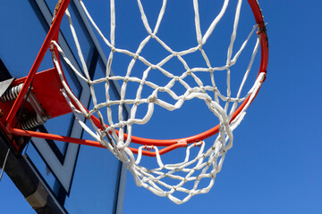 Transparent basketball hoop on blue sky background