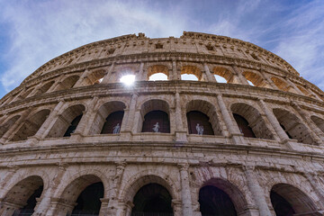 The great Roman Colosseum also known as the Flavian Amphitheater on a sunny day with deep blue sky, beautiful clouds and no people visible 