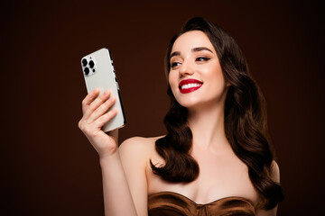 Photo of lovely rich happy girl wear fashionable clothes use gadget isolated on brown color...