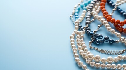 Obraz premium Colorful Strings of Elegant Jewelry on Soft Blue Background