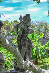 Balinese statue in the middle of a garden, Bali, Indonesia
