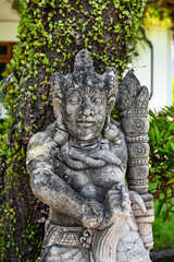 Balinese statue in the middle of a garden, Bali, Indonesia
