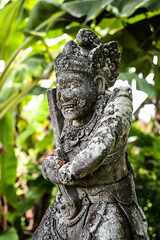 Balinese statue in the middle of a garden, Bali, Indonesia