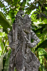 Balinese statue in the middle of a garden, Bali, Indonesia