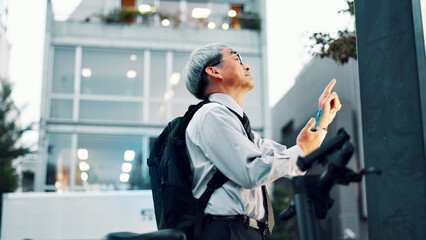 Businessman, phone or electrical bike in street for travel, clean energy or sustainable transport....