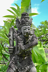 Balinese statue in the middle of a garden, Bali, Indonesia