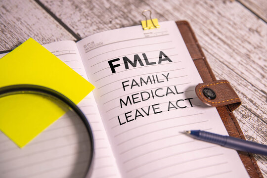 Family And Medical Leave Act FMLA written on notebook with stethoscope, syringe and pills.