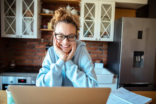 Young woman working on laptop at home
