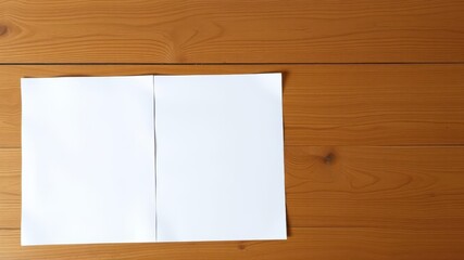 Naklejka premium Two pieces of white paper mockup on a wooden table, top view