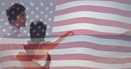 American flag image over couple embracing and looking at ocean