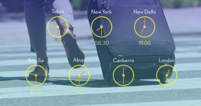 Image of clocks with time in time zones over man walking with suitcase - Powered by Adobe