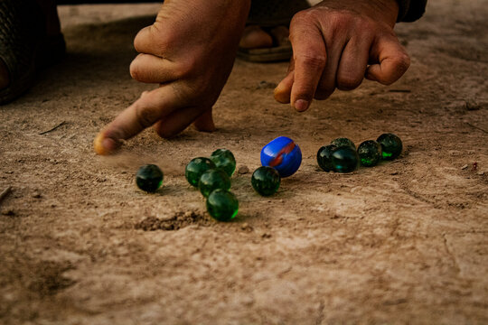 Kids playing marbles, Kanche Game, Peshawar culture, Indian Kancha game, Kaanche, Child playing marbles.