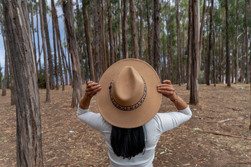 Young latina tourist enjoying the eucalyptus forest in qenqo cusco