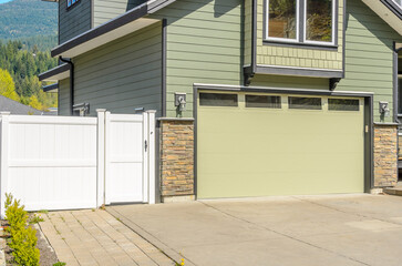 Garage door in luxury house with trees and nice landscape in Summer in Vancouver, Canada, North...