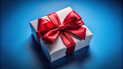 Obraz premium A single white gift box tied with a bright red satin ribbon, sitting on a vibrant blue background, ready to be opened