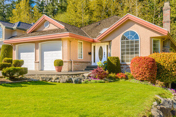 Garage door in luxury house with trees and nice landscape in Summer in Vancouver, Canada, North...