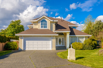 Garage door in luxury house with trees and nice landscape in Summer in Vancouver, Canada, North America. Day time on June 2024.