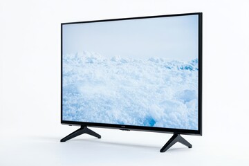 Fototapeta premium Modern flat-screen tv displaying snowy landscape on a minimalist stand