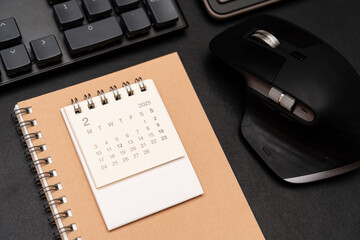 Simple desk calendar for FEBRUARY 2025 with office supplies. Calendar concept with copy space. 2025...