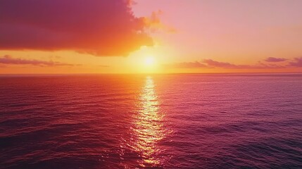 Fototapeta premium Vivid Sunset Over a Calm Sea with Bright Orange and Pink Hues Cast Across the Water, Creating a Serene and Peaceful Atmosphere at Dusk