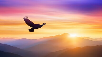 Fototapeta premium A majestic bird flying silhouette above a mountain range at dawn, symbolizing freedom.