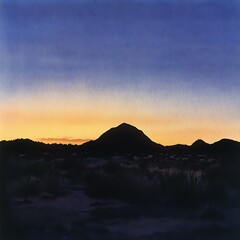 Serene Sunset over Silhouetted Mountains and Desert Landscape.