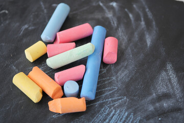 Brightly Colored Chalk Pieces Scatter Across a Chalkboard Surface