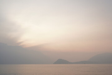 View of Lake Como and the promontory of Bellagio from the lakefront promenade of Menaggio. Italy