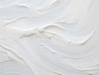 Obraz premium A textured white surface with smooth, flowing patterns resembling paint or cream.