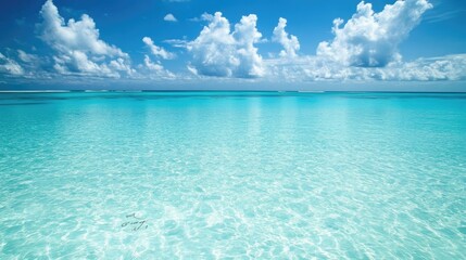 Fototapeta premium Majestic Tropical Seascape with Crystal Clear Turquoise Waters Under a Bright Blue Sky Filled with Fluffy White Clouds Perfect for Vacation and Relaxation Themes